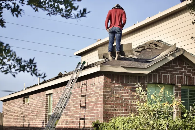 Professional roofer working on a residential roof in Plover